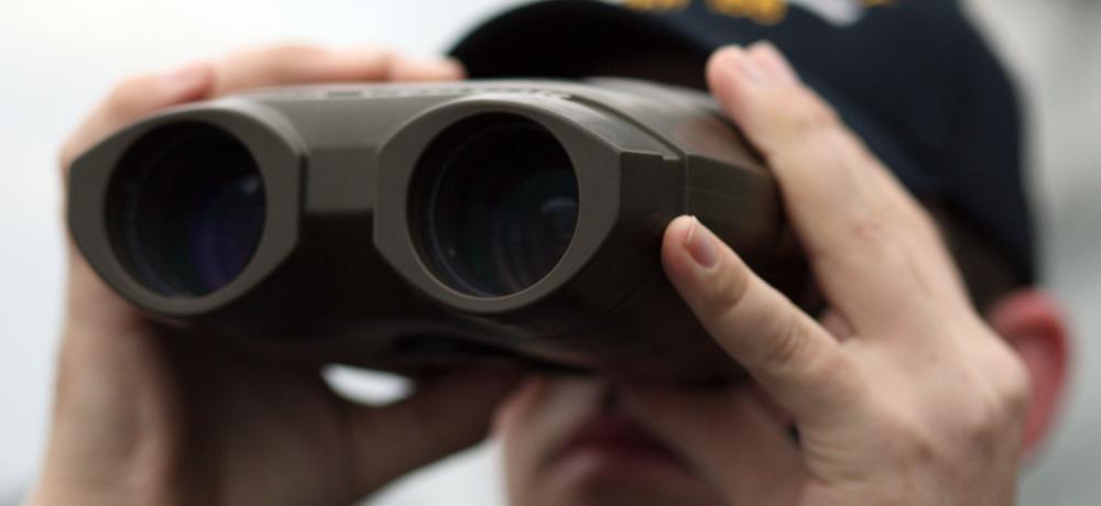 RAN member looks through a set of binoculars during exercise Talisman Sabre 2011.