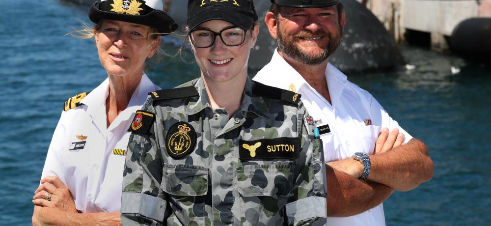 Lieutenant Karin Leepere stands back to back alongside Chief Petty Officer Lee Webster with Seaman Marine Technician Danielle Sutton standing in front near Diamantina Pier at Fleet Base West.