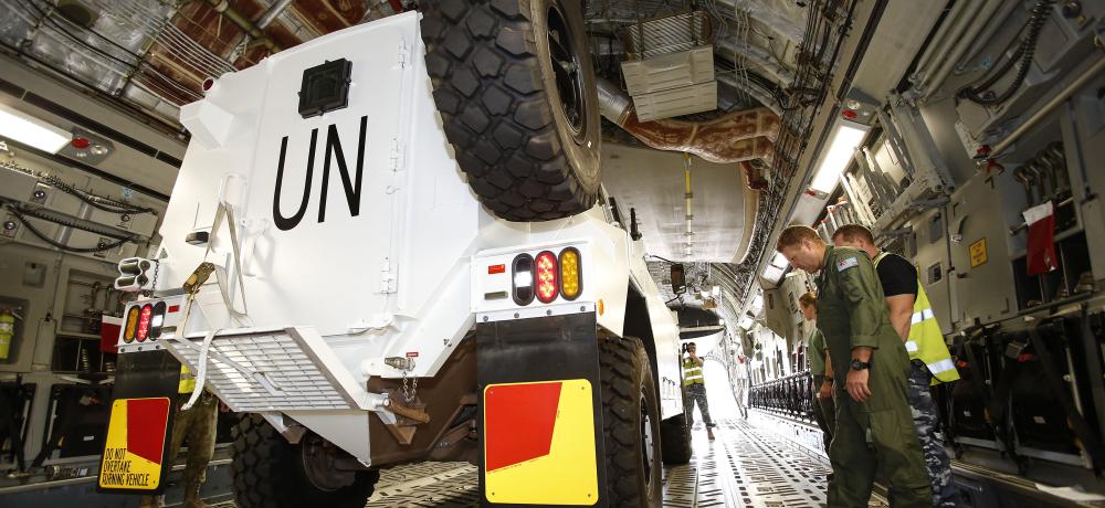 A Bushmaster Protected Mobility Vehicle (PMV) is loaded onto a C-17 Globemaster at RAAF Base Amberley.