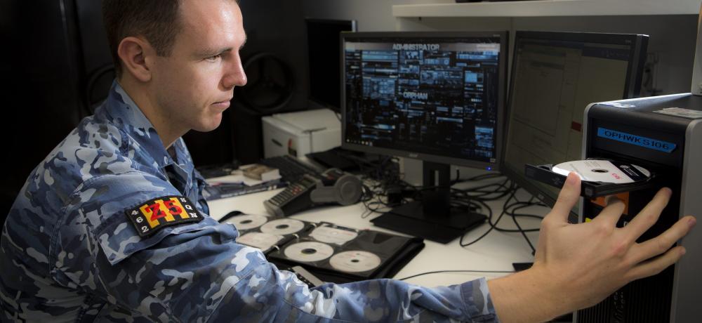 Communication Information Systems Controller, Leading Aircraftman Jacob Nolan, prepares to install new software onto one of the 'Orphan' Network computers in No 462 Squadron located within the Edinburgh Defence Precinct.