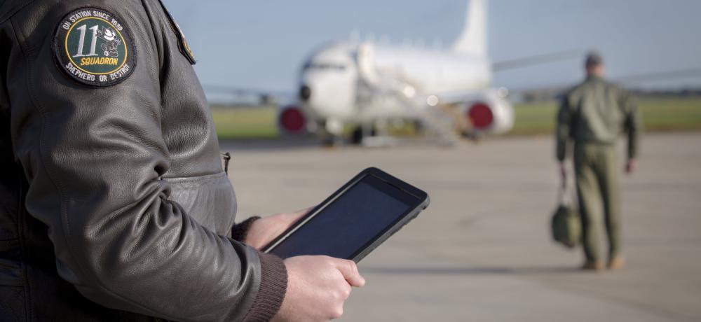 Flying Officer Charlie Goodacre checks mission data on an IPAD before a sortie on the P-8A Poseidon out of RAAF Base Edinburgh.