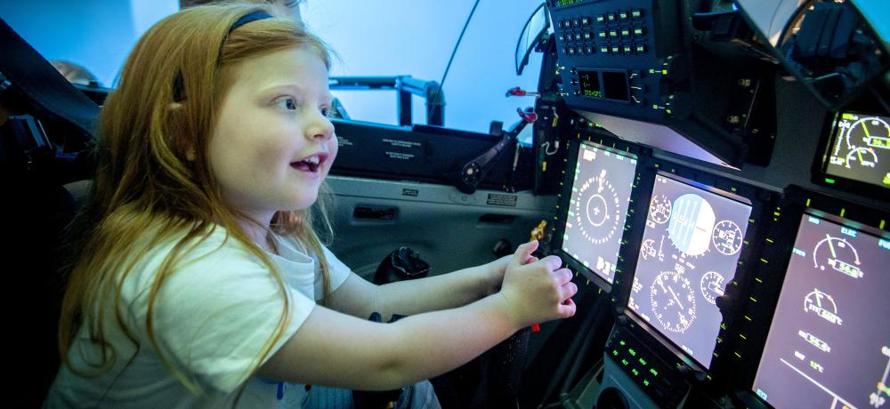 2020 Little Telethon Star, Norah Holly takes control in a flight simulator with Flight Lieutenant Andrew Muhl during a visit to RAAF Base Pearce in Western Australia for a tour of the base and an insight into life as a member of the Royal Australian Air Force.