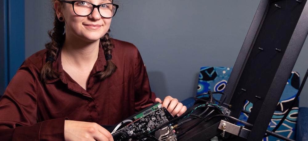 Elaine Garrett, one of the students with her robot taking part in the Defence Science, Technology, Engineering and Mathematics (DSTEM) summer vacation program at Defence Science and Technology Group (DSTG) in Edinburgh, SA.