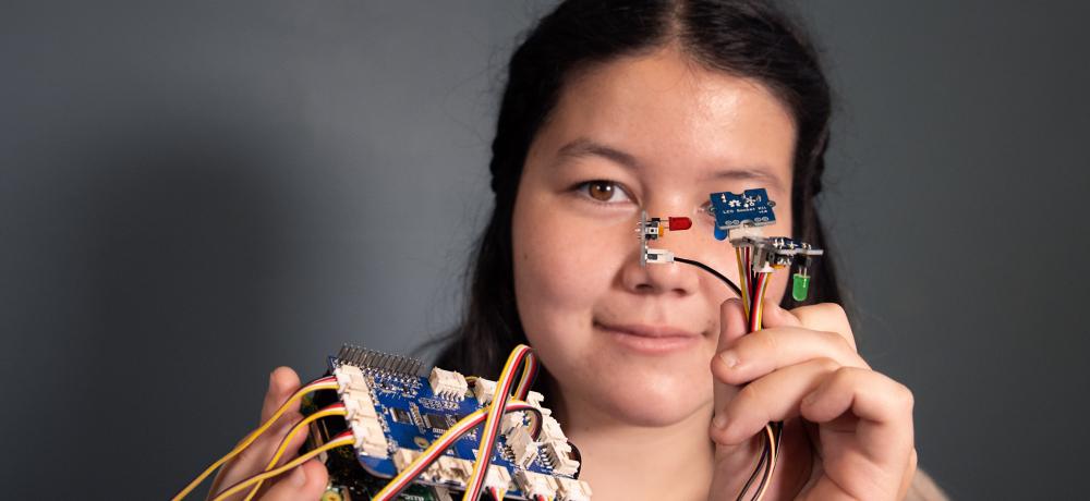 Naomi Smith, one of the students with her robot taking part in the Defence Science, Technology, Engineering and Mathematics (DSTEM) summer vacation program at Defence Science and Technology Group (DSTG) in Edinburgh, SA.