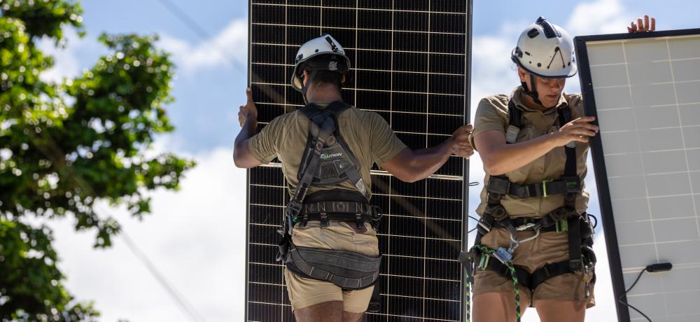 (l-r) Australian Army soldiers Privates Osama Ahmed and Hayley Freeman install solar panels on the roof of the Bwatnupni Police Post, to power radio batteries in support of the Vanuatu Government National Emergency Radio Network.