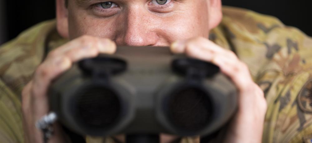 Australian Army soldier Bombadier Mitchell Yates looks over range finding binoculars at the Army Reserve Kogarah Depot, Sydney, New South Wales.