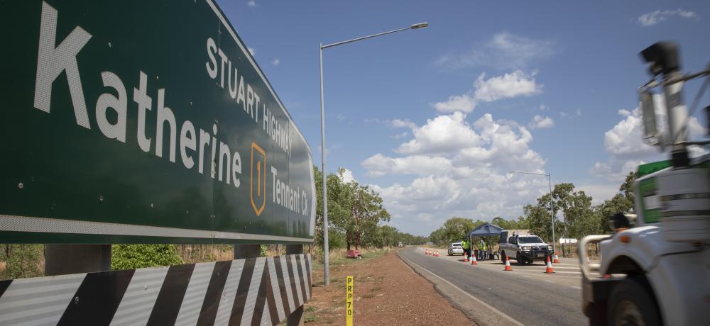 A truck approaches a vehicle control point on the Stuart Highway manned by Australian Defence Force members and Northern Territory Police.