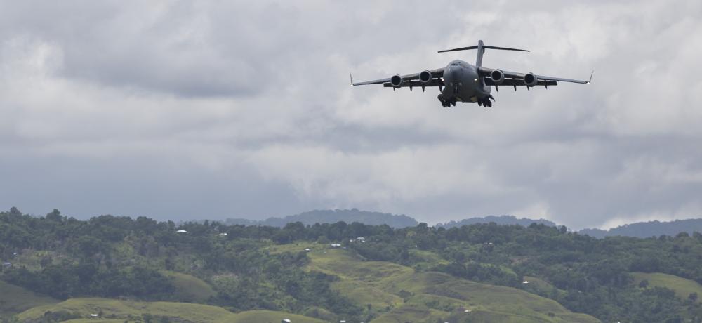 A Royal Australian Air Force C-17A Globemaster III aircraft descends for landing at Honiara international airport, Solomon Islands.