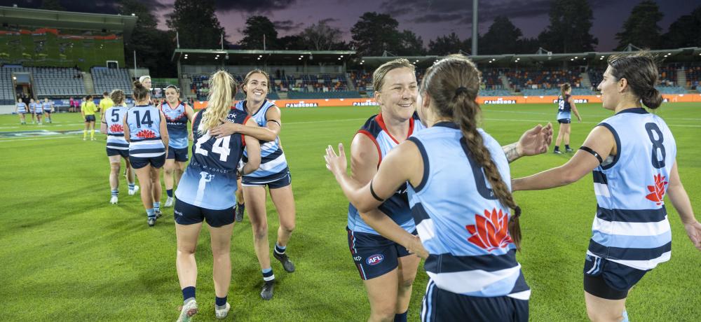 Australian Defence Force Women’s All-Stars AFL team and the New South Wales Police Force women's team players shake hands after the Anzac Challenge Cup game at Manuka Oval in Canberra on Friday, 22 April 2022.