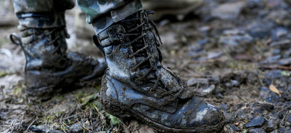 The mud encrusted boots of a Royal Australian Navy Sailor after completing the removal of fallen and dangerous trees from Traralgon Creek Road, Koornalla, Victoria.