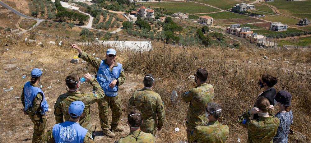 A group of ADF members on a UN mission stand in a group overlooking the Lebanese-Israeli border