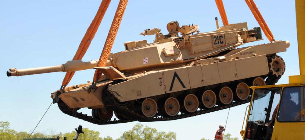 An M1A1 Abrams Tank from the 1st Armoured Regiment is lifted for placement onto purpose built rolling stock at Berrimah Rail Yard in the Northern Territory.