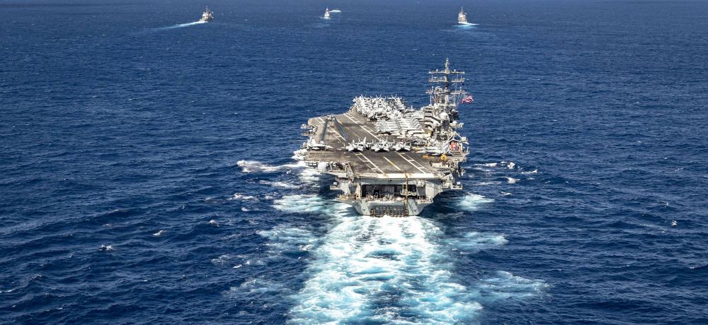 USS Ronald Reagan (CVN 76), steams in formation with the Royal Australian Navy ship HMAS Perth (FFH 157), as well as other vessels.