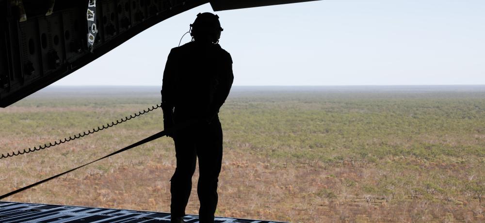 A loadmaster of a Royal Australian Air Force No.36 Squadron C-17A Globemaster III admires the vastness of the outback of Australia during a training mission for Exercise Diamond Storm 24.