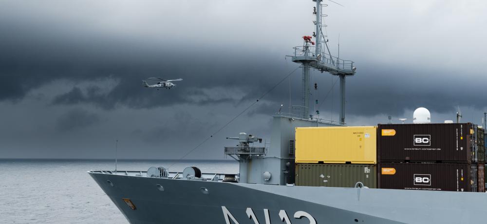 HMAS Sydney’s embarked MH-60R helicopter “Phoenix” flies past German Navy ship FGS Frankfurt am Main during a replenishment at sea as the ships conduct cooperation activities in the Yellow Sea during Operation Argos.