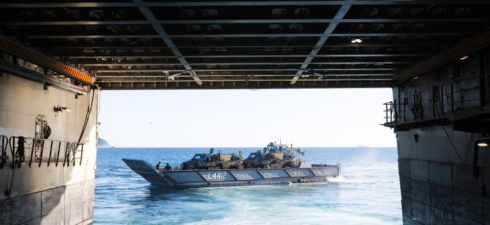 A Light Landing Craft (LLC) carrying two Bushmaster Protected Mobility Vehicles departs HMAS Canberra during a Wet and Dry Environmental Rehearsal (WADER) operation during Exercise Talisman Sabre 2025.
