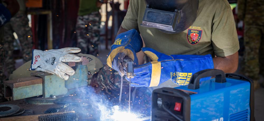 Soldiers from the Timor-Leste Defence Force practice welding under supervision from a member of the Royal New Zealand Army Logistics Corps during Exercise HARI'I HAMUTUK 2024, in Metinaro Military Base, Timor-Leste.