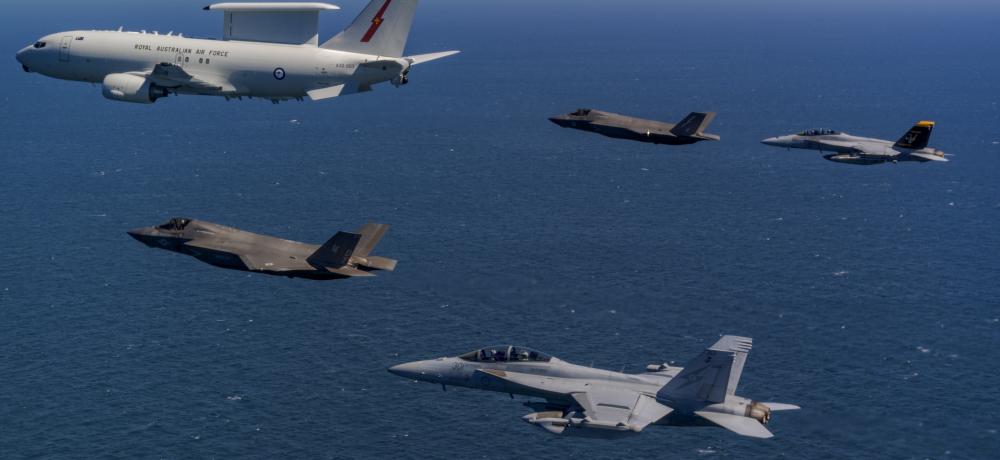 Royal Air Force and United States Marine Corps F-35B Lightning IIs and a EA-18G Growler fly along with a Royal Australian Air Force E-7A Wedgetail over the Northern Territory airspace during Exercise Talisman Sabre 2025.