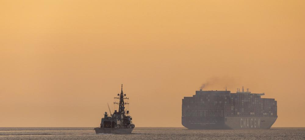 Japan Maritime Self-Defense Force destroyer and merchant vessel navigating the Malacca Strait 