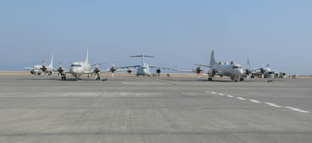 Australian, American, and Japanese aircraft on the tarmac at Marine Corps Air Station Iwakuni in Japan during a trilateral training and engagement activity. RAAF P-8A Poseidon; Japan Maritime Self-Defense Force EP-3 Orion; Japan Air Self-Defense Force RC-2