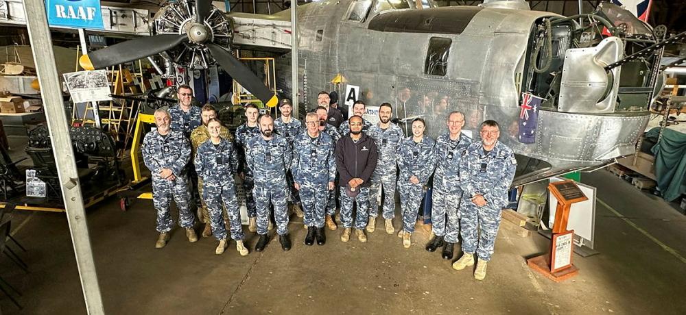 Royal Australian Air Force members from Number 21 Squadron stand proudly in front of a B-24 Liberator bomber, an airframe operated by the squadron in the closing years of World War Two, during a tour of the B-24 Liberator Restoration Museum in Werribee, Victoria