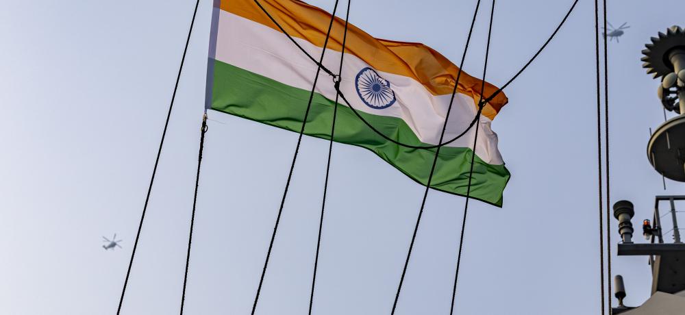 Indian Navy Ka-27 helicopters fly over HMAS Warramunga, with the National Flag of India.ing a review rehearsal for the preparation of India's International Fleet Review 2026.