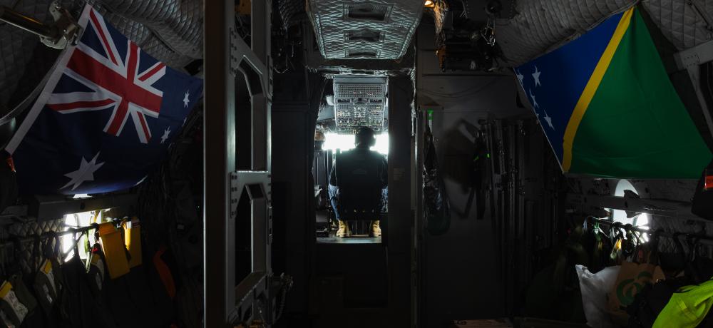 Australian and Solomon Islands flags inside a Spartan aircraft.