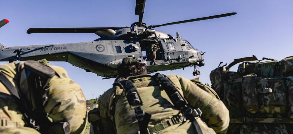 Australian 5th Brigade soldiers board an RNZAF NH90 Helicopter.