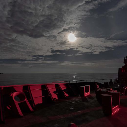 HMAS Ballarat sails under a full moon with USS John S. McCain en route to Exercise Malabar 2020.