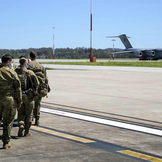 Australian Army Officer Cadets from Queensland University Regiment walk towards a Royal Australian Air Force C-17 Globemaster aircraft from 36 Squadron, during Exercise Monash at RAAF Base Amberley, Queensland.