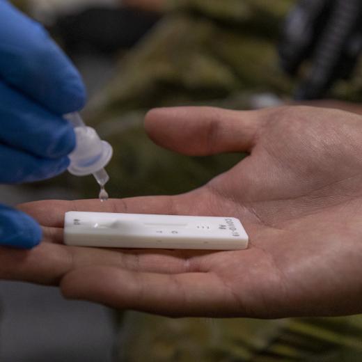 Australian Army Private Bianca Jordan from Joint Task Group 637.3 delivers the COVID 19 Rapid Antigen test to Australian soldiers at Rove Police Headquarters.