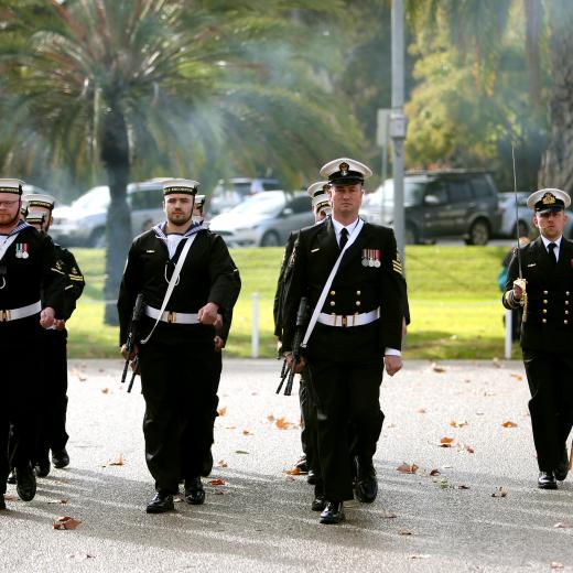 Royal Australian Navy sailor Petty Officer Physical Training Instructor Martin Kaye leads the guard for HMAS Encounter at the commencement of their commissioning ceremony at Torrens Parade Ground, Adelaide, South Australia.