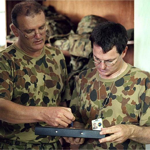 The Naval Component Commander CDRE Jim Stapleton (left) with CMDR Daryl Bates NCC Chief of Staff (right) at INTERFET HQ in Dili. PIC: ABPH Damian PawlenkoRAN8095516_19990124_220 UNCLASSIFIED Not Cleared for transmission Not Approved for Release