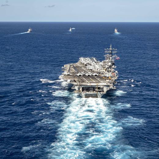 USS Ronald Reagan (CVN 76), steams in formation with the Royal Australian Navy ship HMAS Perth (FFH 157), as well as other vessels.