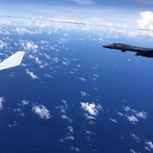 A United States Air Force B-1 Lancer aircraft alongside a Royal Australian Air Force KC-30A Multi-Role Tanker Transport aircraft above Guam as part of an Australia/US interoperability mission during the Regional Presence Deployment.