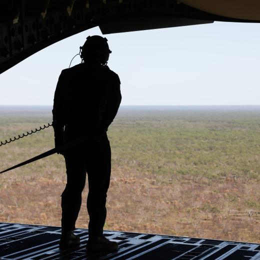 A loadmaster of a Royal Australian Air Force No.36 Squadron C-17A Globemaster III admires the vastness of the outback of Australia during a training mission for Exercise Diamond Storm 24.