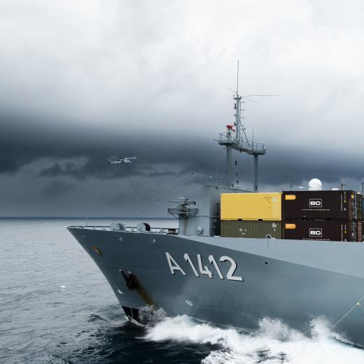 HMAS Sydney’s embarked MH-60R helicopter “Phoenix” flies past German Navy ship FGS Frankfurt am Main during a replenishment at sea as the ships conduct cooperation activities in the Yellow Sea during Operation Argos.