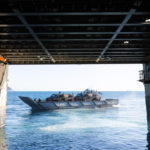 A Light Landing Craft (LLC) carrying two Bushmaster Protected Mobility Vehicles departs HMAS Canberra during a Wet and Dry Environmental Rehearsal (WADER) operation during Exercise Talisman Sabre 2025.