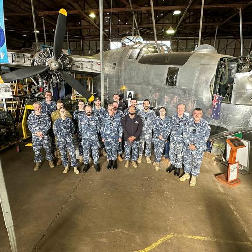 Royal Australian Air Force members from Number 21 Squadron stand proudly in front of a B-24 Liberator bomber, an airframe operated by the squadron in the closing years of World War Two, during a tour of the B-24 Liberator Restoration Museum in Werribee, Victoria