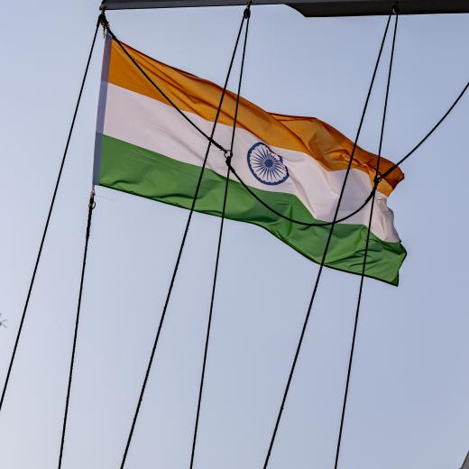 Indian Navy Ka-27 helicopters fly over HMAS Warramunga, with the National Flag of India.ing a review rehearsal for the preparation of India's International Fleet Review 2026.