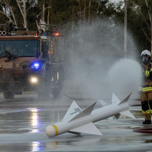 Fire fighter keep a training missile cool