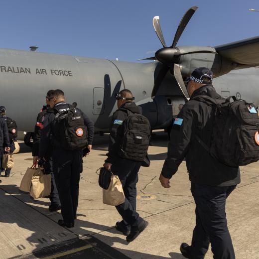 Pacific Police Support Group, board a Hercules 
