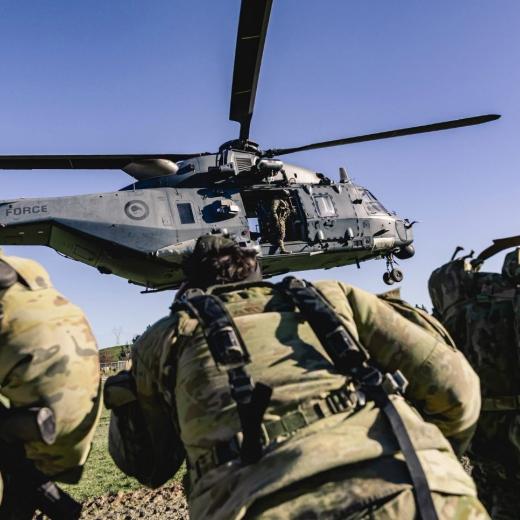Australian 5th Brigade soldiers board an RNZAF NH90 Helicopter.